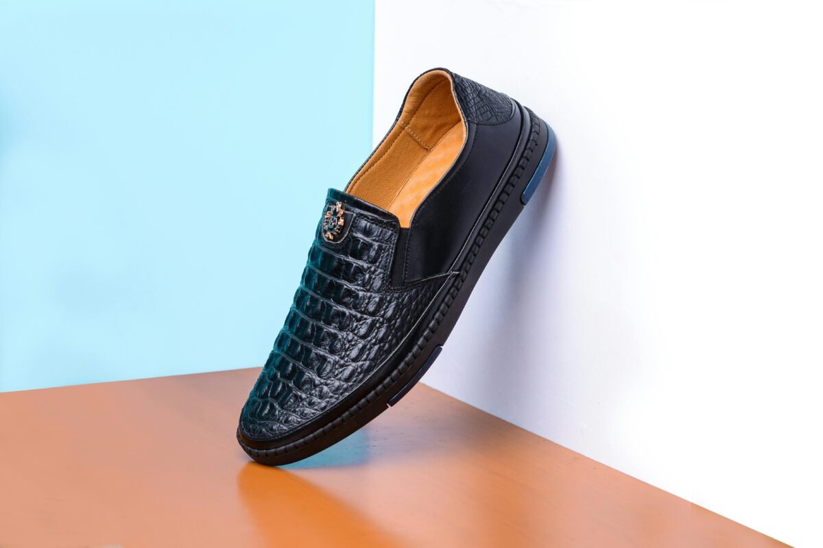 Stylish black leather shoe elegantly displayed, highlighting luxury fashion design.